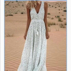 White, flowy V-neck dress with black polka dots